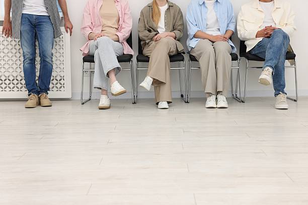 istock People waiting in queue on chairs indoors, closeup 2236757658
