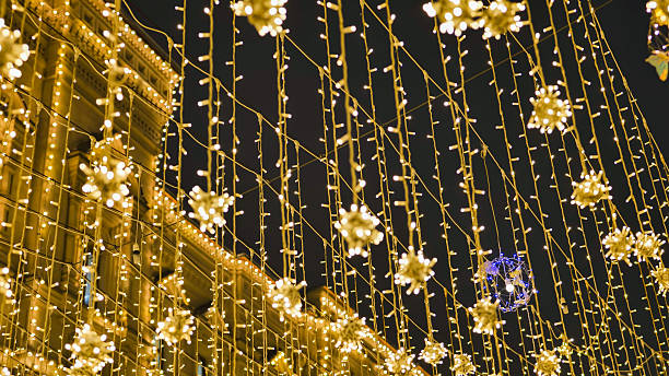 istock Hanging christmas lights illuminating a building at night 2236758130