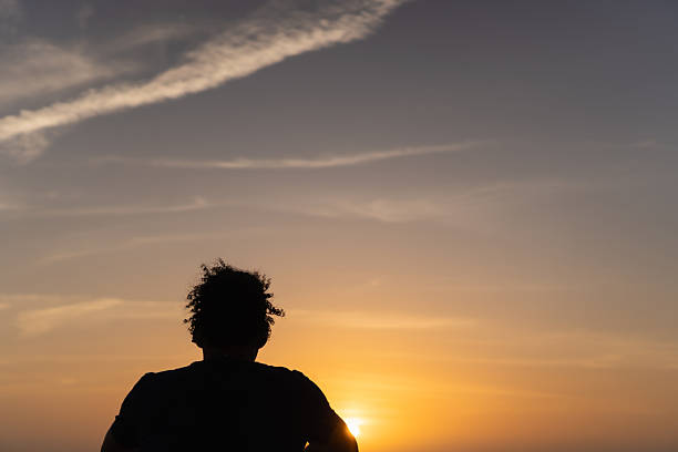 istock Man contemplating sunset, finding peace and solitude outdoors 2236758231