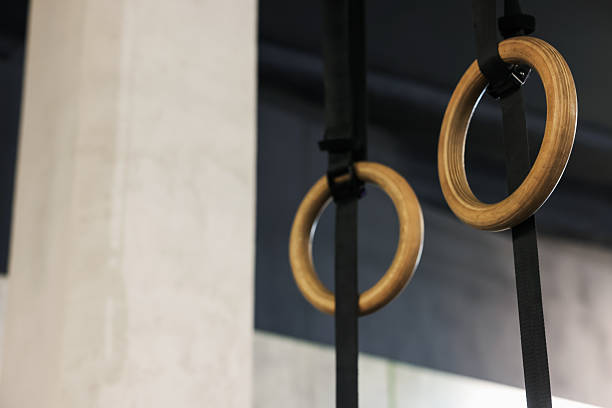 istock Gymnastic rings hanging in gym, low angle view. Space for text 2236759642