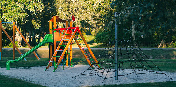 istock Colorful playground equipment with slide and climbing net in park 2236760061