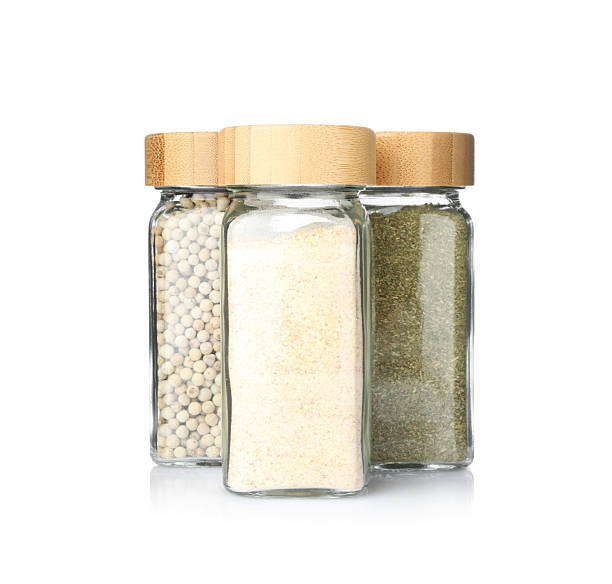 istock Different aromatic spices in glass jars isolated on white 2236760478