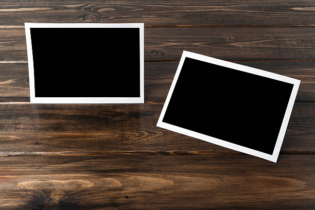 istock Blank photo frames for your photos on wooden background 2236762448