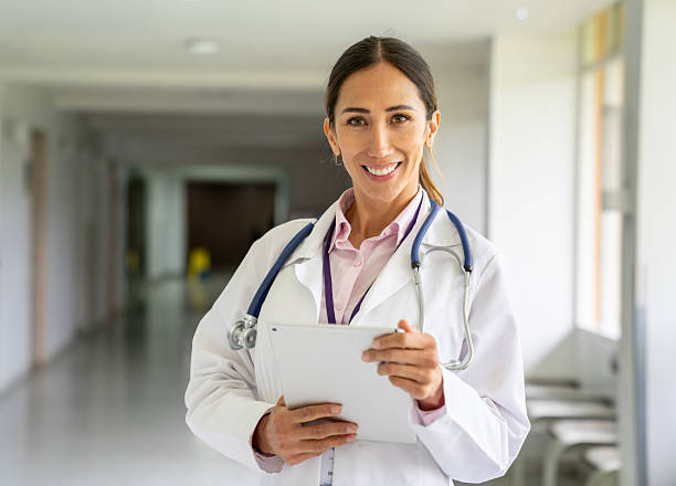 istock Portrait of a doctor smiling while using a tablet at the hospital 2236762531