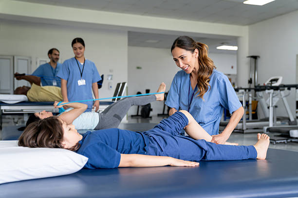 istock Boy doing leg exercises with a physical therapist after having an injury 2236762574