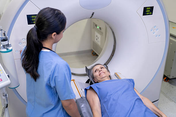 istock Senior woman talking to a technician before getting a CAT scan 2236762653