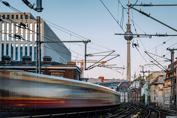 istock Berlin City Rail: Blurred Subway On Tracks Under Overhead Wires With Fernsehturm Tower 2236763413