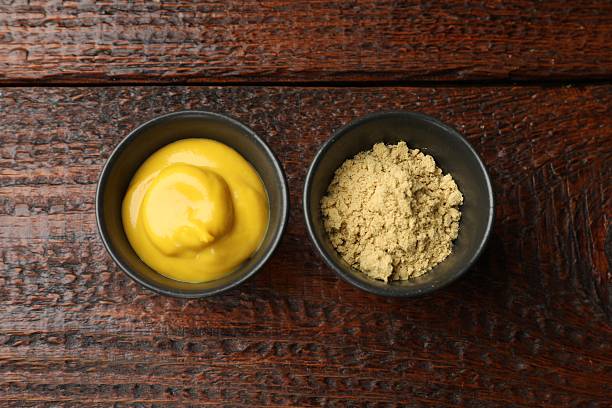 istock Different types of mustard on wooden table, flat lay 2236764371