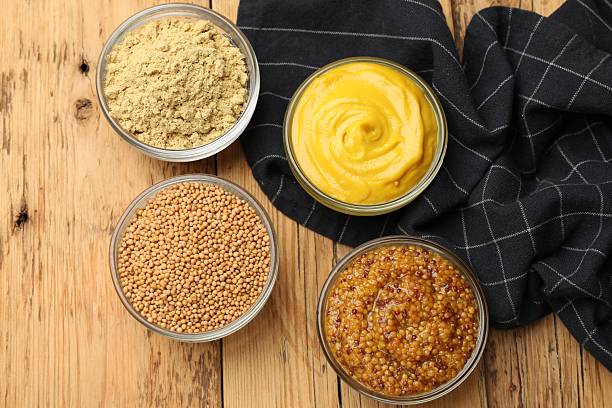 istock Different types of mustard on wooden table, flat lay 2236764400