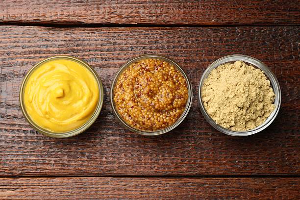 istock Different types of mustard on wooden table, flat lay 2236764413