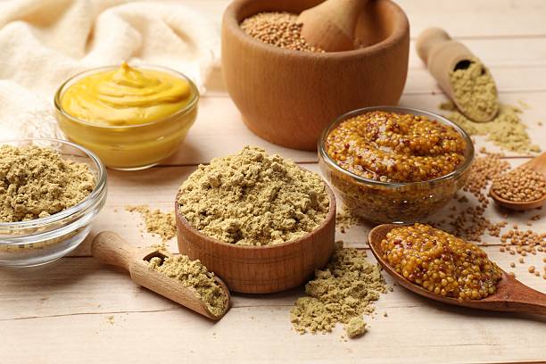 istock Different types of mustard on wooden table, closeup 2236764422