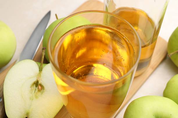 istock Fresh cider in glass, bottle, apples and knife on table, closeup 2236765252