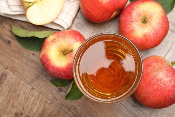 istock Fresh cider in glass and apples on wooden table, flat lay 2236765263