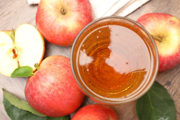 istock Fresh cider in glass and apples on wooden table, flat lay 2236765865