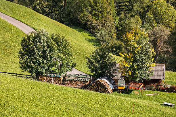 Summer in the Dolomites, Italy, farm houses, wooden cabins, tractor, ecological tourism concept