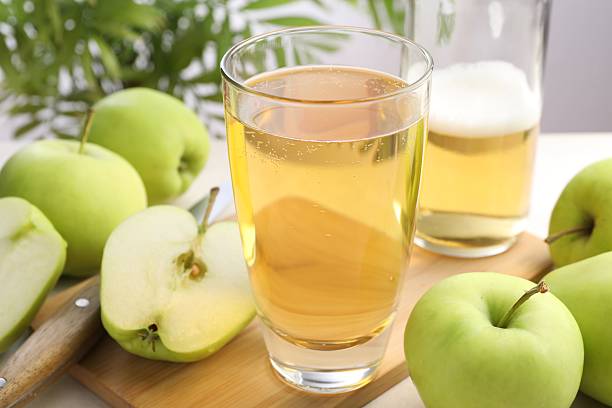 istock Fresh cider in glass, bottle, apples and knife on table, closeup 2236765906