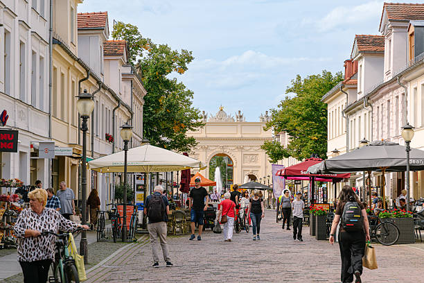 istock Vibrant Potsdam Street Scene With Shops, Cafes, And Arch Gate In View 2236766021