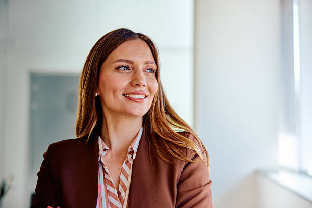 istock Confident young businesswoman smiling in bright modern office 2236766596