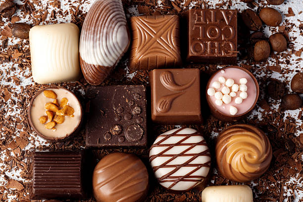istock Chocolate candies and chocolate pieces pile for background 2236766720