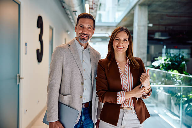 istock Successful business colleagues smiling with confidence in modern office hallway 2236766814