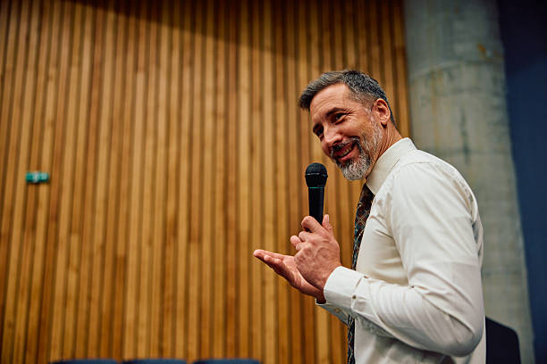 istock Confident mid adult man speaking with microphone on stage 2236767063