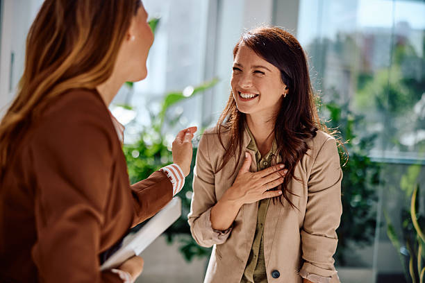 istock Two young businesswomen sharing joyful conversation 2236767152