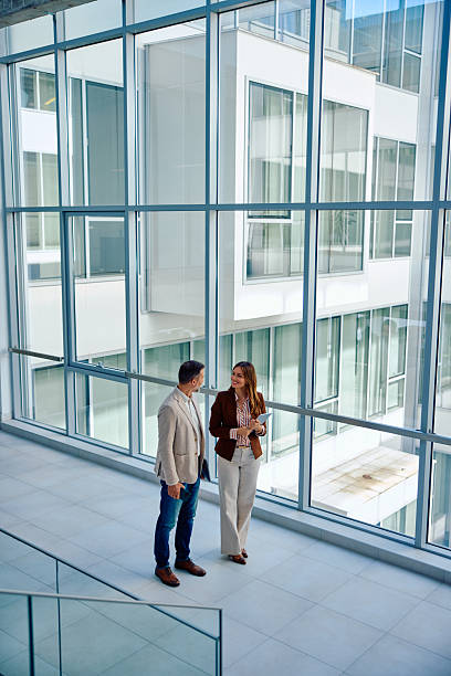 istock Business professionals discussing strategy in modern glass office building 2236767299