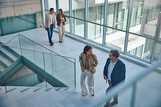 istock Group of business professionals walking inside modern office building 2236767313