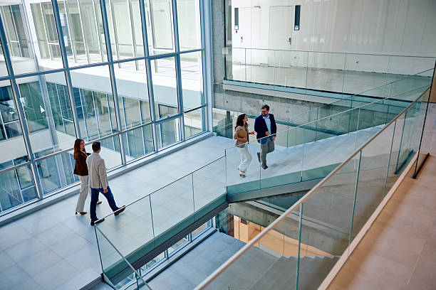 istock Modern business professionals walking inside corporate office building 2236767326
