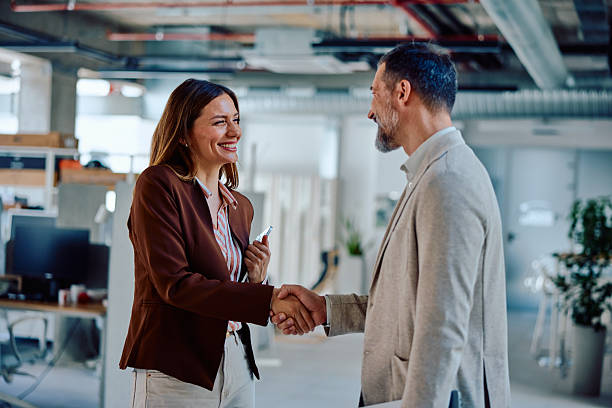 istock Successful business agreement handshake in modern office setting 2236767353