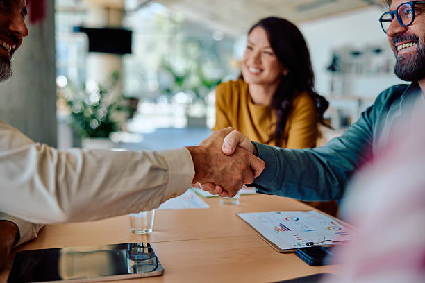 istock Successful business partnership handshake in modern office 2236767391