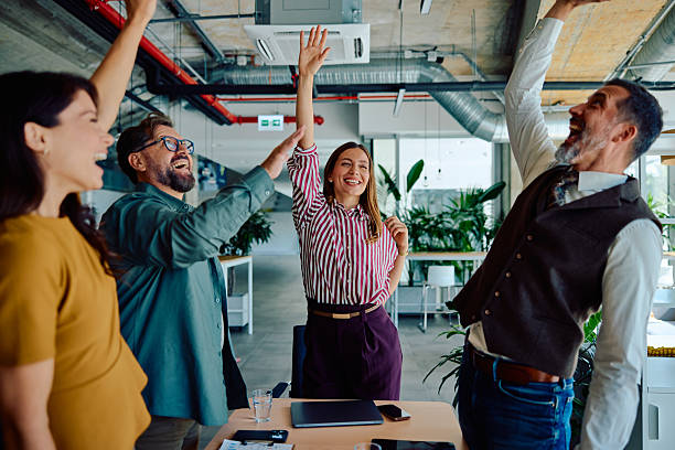 istock Successful business team celebrating achievement together 2236767405