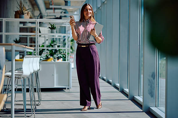 istock Confident young businesswoman walking through modern office corridor 2236767847