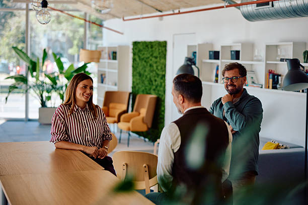 istock Three adults having casual discussion in modern office 2236767885