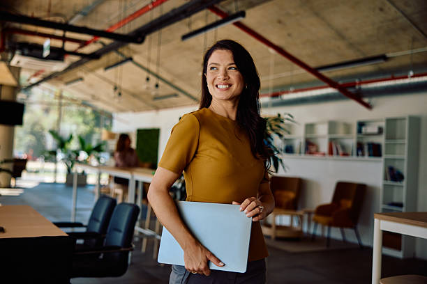 istock Confident businesswoman holding laptop in modern office workspace 2236767902