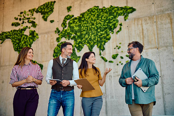 istock Diverse business team discussing ideas in front of green world map wall 2236768018