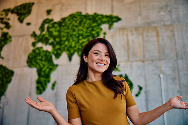 istock Smiling young woman presenting green world map concept 2236768087