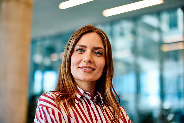 istock Confident young businesswoman smiling in modern office environment 2236768148