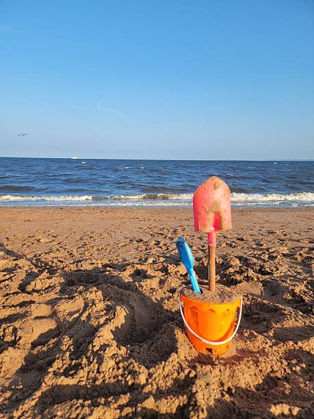 Colorful plastic toys on the beach