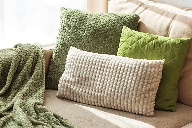 istock Textured Pillows and Blanket on Cozy Beige Sofa 2236774022