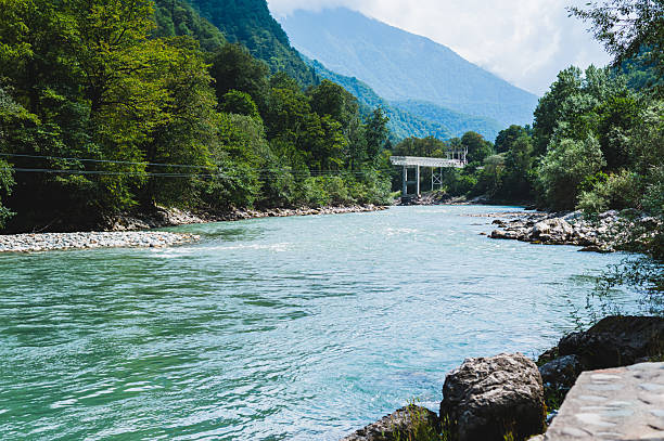 istock Bungee jumping and metal bridge on a mountain blue rocky river on a summer day 2236780963