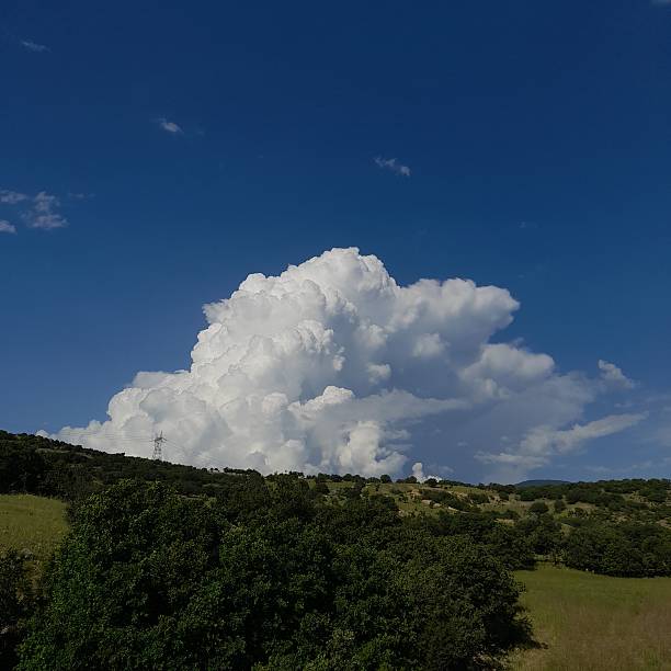istock lush nature landscape and cumulonimbus cloud. 2236782080