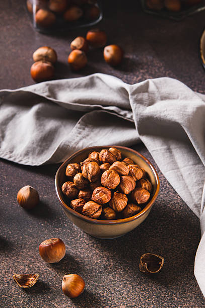 istock Nourishing hazelnuts without shells in a bowl for diet on the table vertical view 2236782085