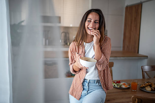 istock Young woman enjoying healthy snack in modern kitchen 2236782120