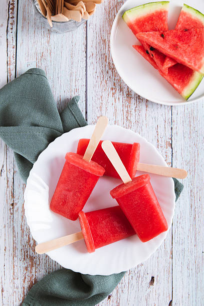 istock Red watermelon popsicle ice cream on a plate on the table top and vertical view 2236783877