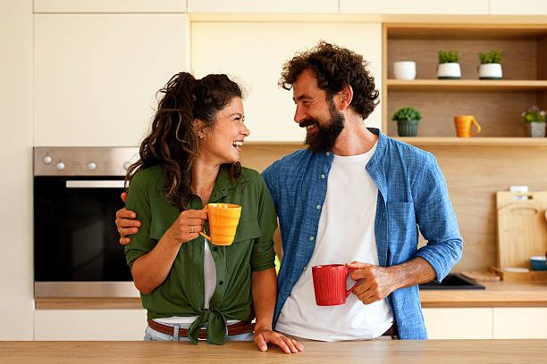 istock Happy couple enjoying morning coffee together in modern kitchen 2236784487