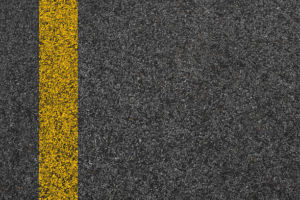 istock White And Yellow Stripes On Asphalt Road Texture. 2236785637