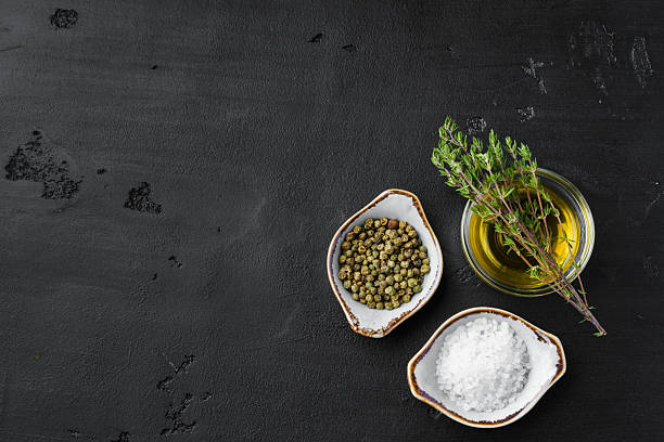 istock Olive oil, herbs and spices on black background 2236788155