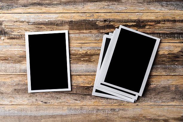 istock Blank photo frames for your photos on wooden background 2236788564