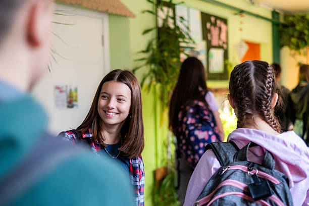 istock Teenage students talking in school hallway after class 2236788724